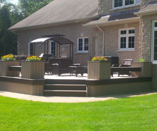low height custom deck attached to modern home in Ottawa with planters around the perimeter